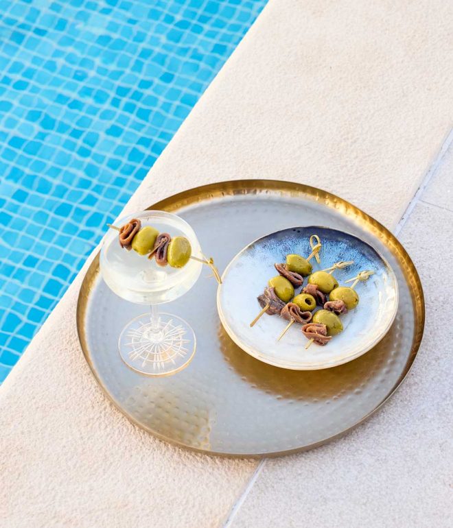 cocktail and canapes on a tray by the pool Algarve Portugal