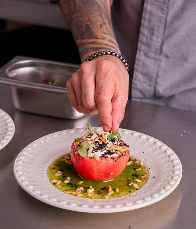 Chef adding final touches on plate Portugal