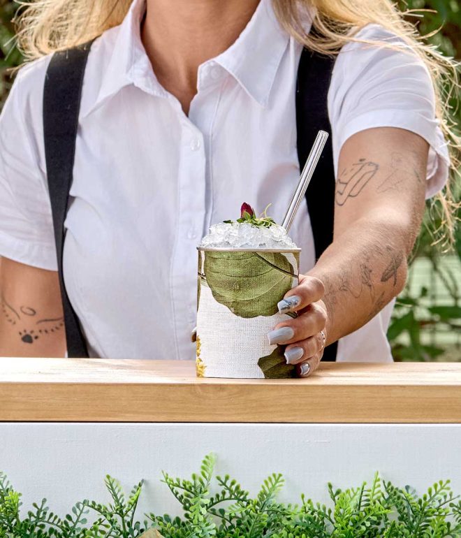 Bartender serving tiki inspired cocktail outdoors Algarve Portugal