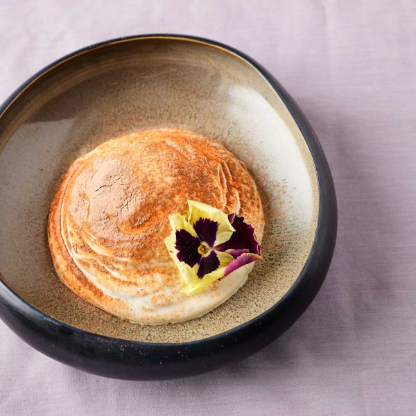 Dessert with flower as garnish in a bowl on the table Algarve Portugal