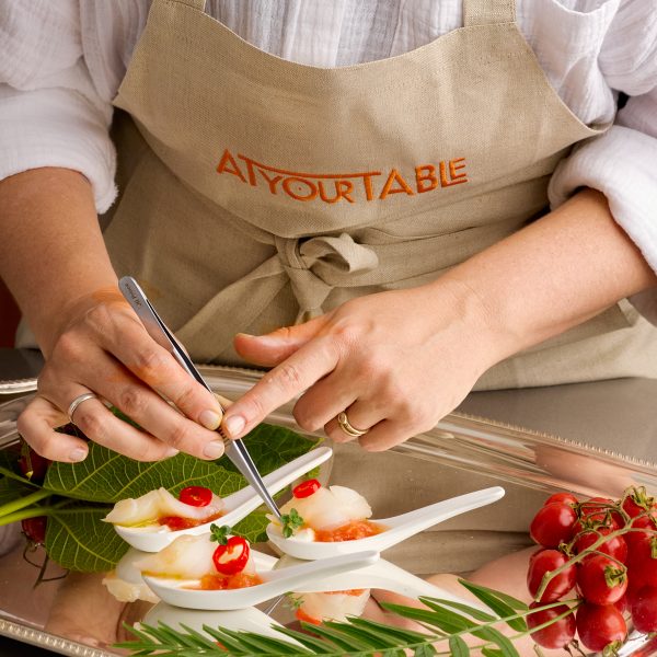 chef garnishing canapes on a spoon
