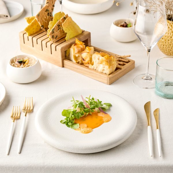 Food on a white plate on the table with other food in the middle