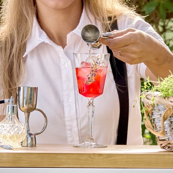 cocktail being prepared by bartender outside