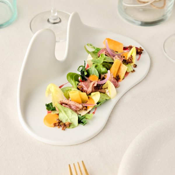 Fine dining salad on a white plate